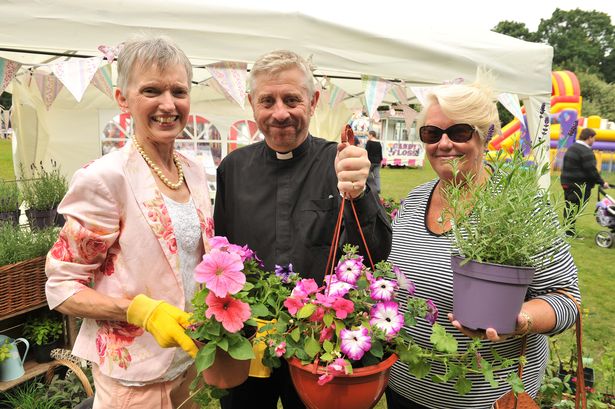 Rev Neale, centre, at the annual Hawley Fair with Diane Brown, left and Denise Dear, right (Image: Surrey Advertiser)