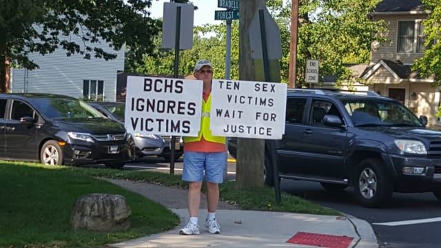 A picketer stands outside of Bergen Catholic High School in Oradell Thursday morning. Photo Credit: Daily Voice Photo