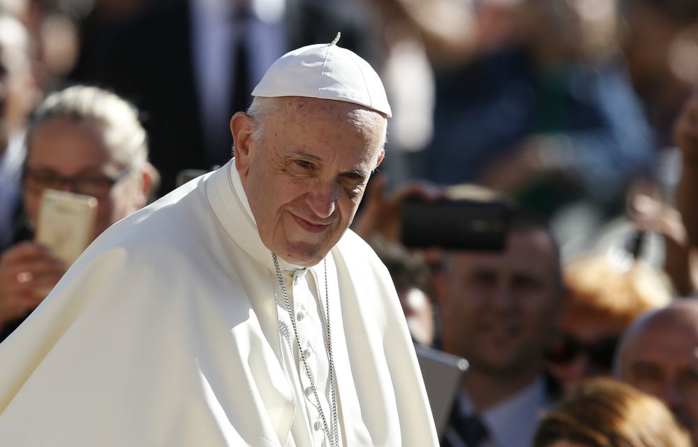 Pope Francis greets the crowd during his general audience in St. Peter's Square at the Vatican Sept. 20. (CNS photo/Paul Haring)