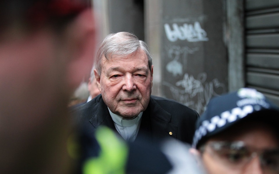 Cardinal George Pell escorted by police arrives at the Melbourne Magistrates Court in Melbourne on Friday CREDIT: AAP VIA EPA