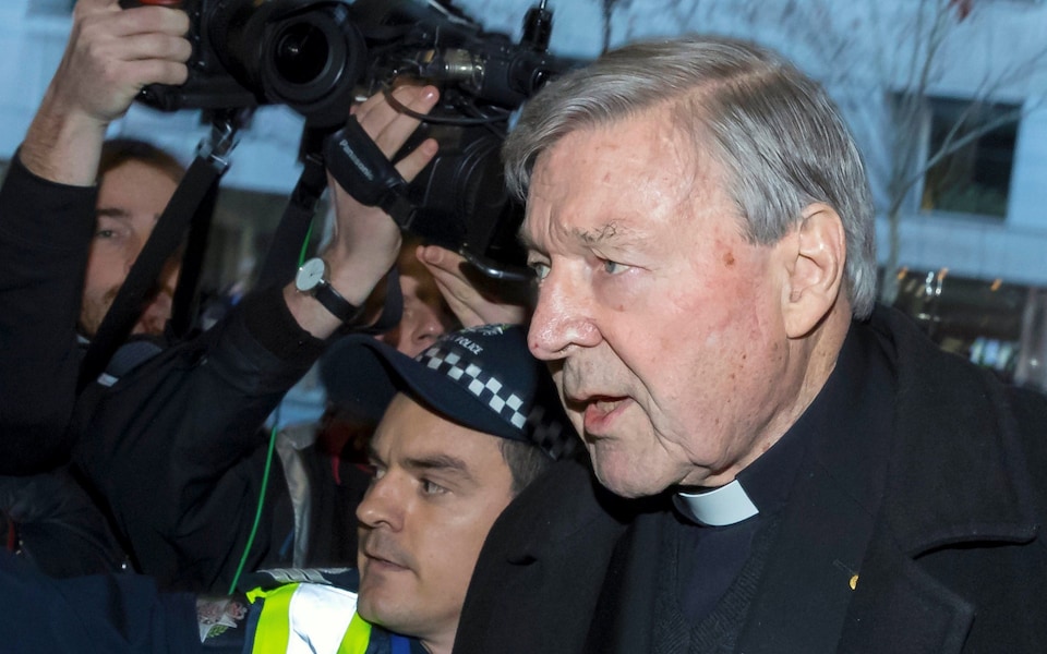 Vatican Treasurer Cardinal George Pell is surrounded by Australian police and members of the media CREDIT: REUTERS
