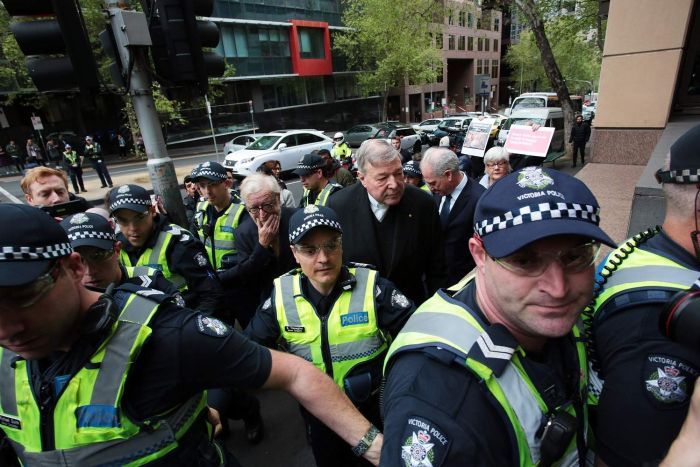 PHOTO: Cardinal George Pell entered the court with a police escort. (AAP: Stefan Postles)