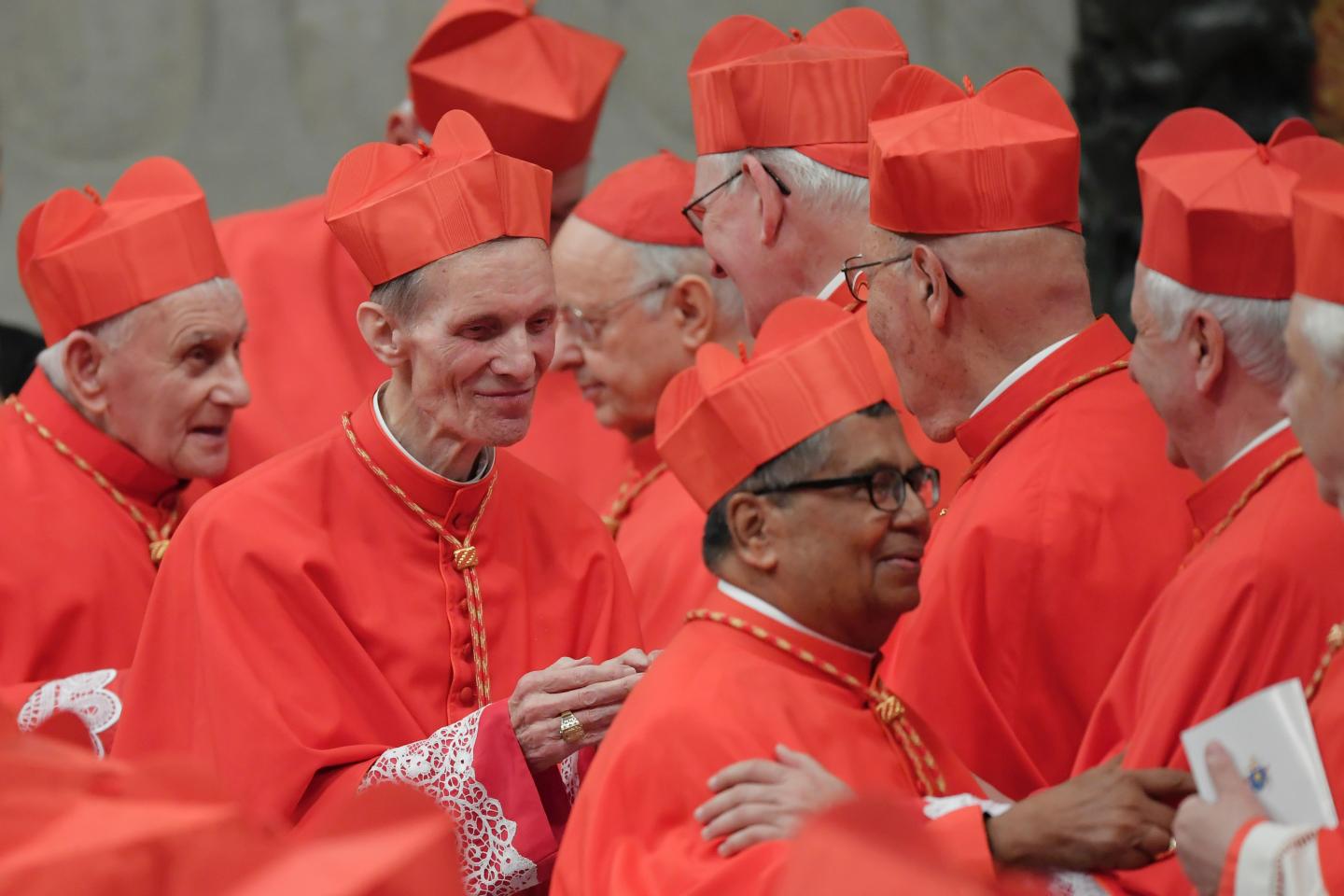 Newly nominated cardinals, archbishop of Kuala Lumpur, Anthony Soter Fernandez (R), bishop of Novara in Italy, Renato Corti (C) and priest from Shkodre-Pult in Albania, Ernest Simoni (L) are congratulated by others cardinals, on November 19, 2016 during a consistory at Peter's basilica. The archdiocese of Naples says he has sent the Vatican a 1,200-page dossier identifying 40 actively homosexual priests and seminarians in Italy.