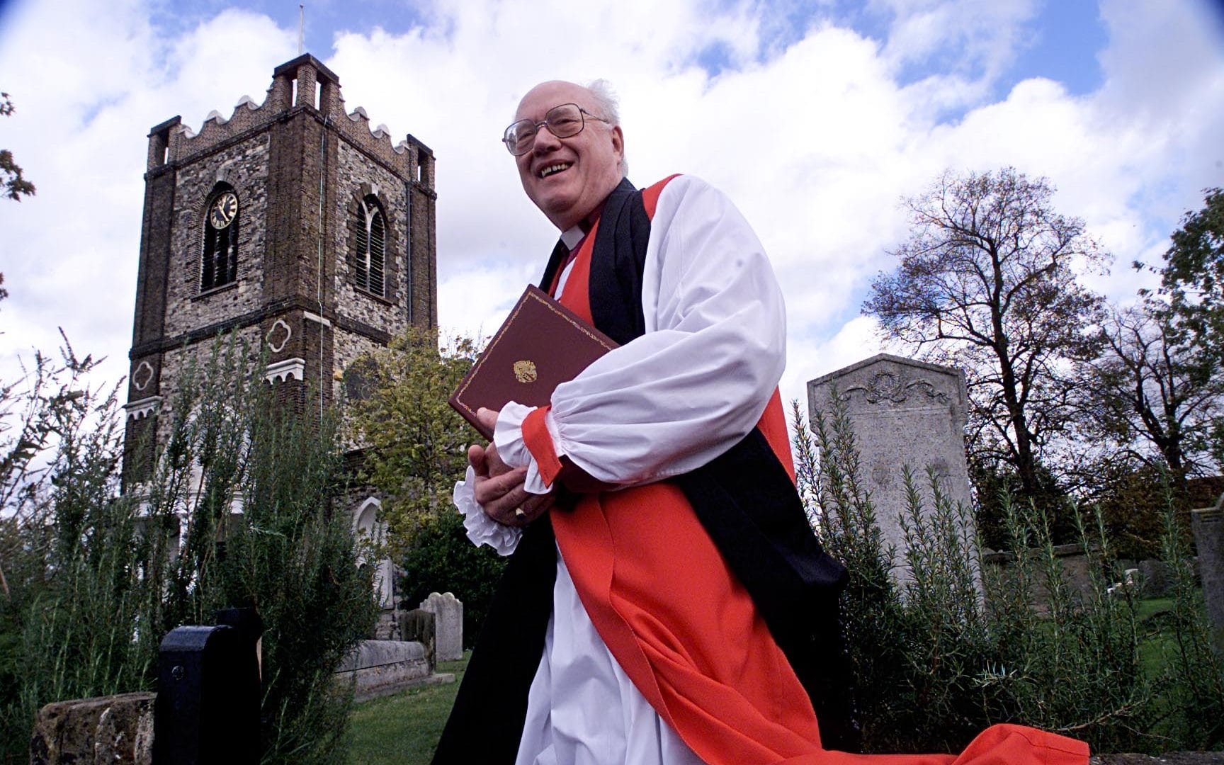 Lord Carey at Dagenham Parish Church. The letter says: 'Why is Lord Carey being targeted at this time? Certain public leaders appear to be being attacked by insinuation without due process.' CREDIT: BRIAN SMITH