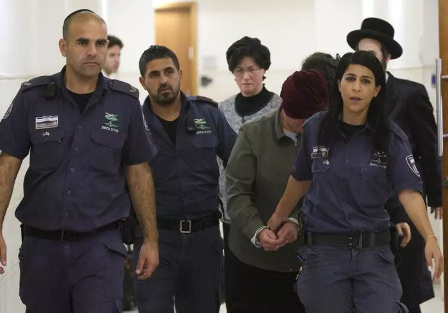 Malka Leifer, a former Australian school principal who is wanted in Australia on suspicion of sexually abusing students, walks in the corridor of the Jerusalem District Court accompanied by Israeli Prison Service guards, in Jerusalem February 14, 2018. REUTERS/Ronen Zvulun. (photo credit: REUTERS/Ronen Zvulun)