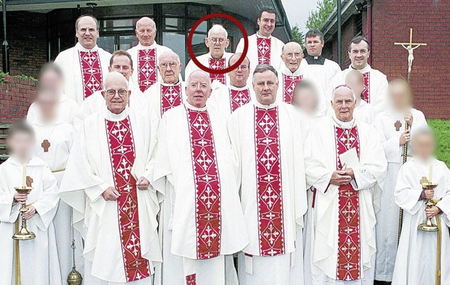 Fr Malachy Finegan, circled, pictured in 2000 with clergy including Dr John McAreavey and Canon Liam Stevenson. Picture courtesy of the Newry Reporter