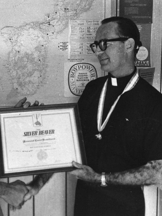 Father Louis Brouillard is shown in this undated Pacific Daily News file photo receiving a Silver Beaver award for his scouting hierarchy from a Navy captain.