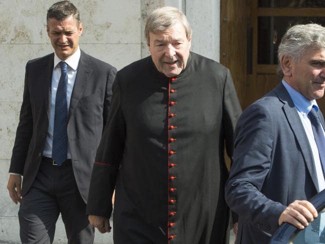 Cardinal George Pell (centre) leaves his home in The Vatican in Rome to hear if Victorian police would prosecute him. Picture: Ben Stevens.