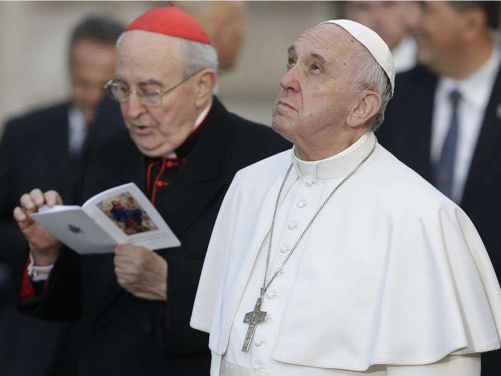 Pope Francis looks up at a statue of the Virgin Mary in downtown Rome, Thursday, Dec. 8, 2016, on occasion of the Immaculate Conception feast. ANDREW MEDICHINI / AP
