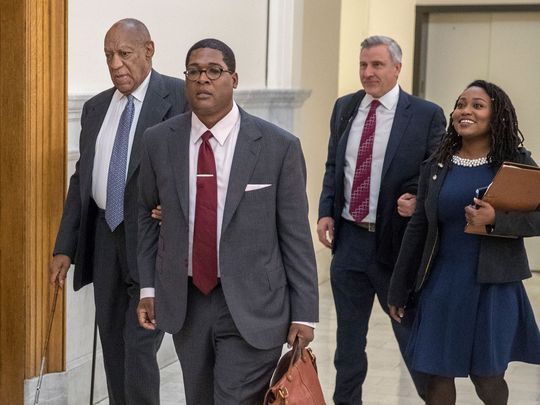 Bill Cosby holds onto spokesman Andrew Wyatt's arm, while publicist Ebonee Benson (R) follows in the courthouse for his sexual assault retrial on April 3, 2018 in Norristown, Pa. (Photo: MICHAEL BRYANT, AFP/Getty Images)