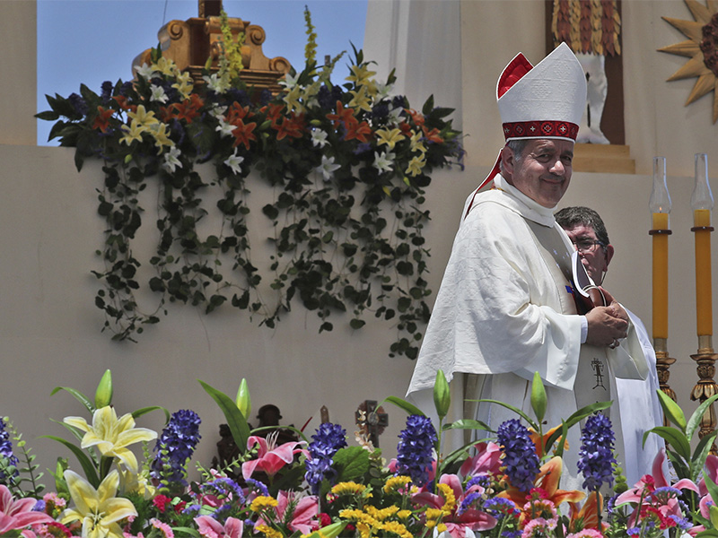 Osorno Bishop Juan Barros smiles as he leaves the altar after Mass was celebrated by Pope Francis on Lobito Beach in Iquique, Chile, Thursday, Jan. 18, 2018. The Vatican said Tuesday, Jan. 30, 2018 that Maltese Bishop Charles Scicluna, the Vatican's most respected sex crimes expert, would travel to Chile "to listen to those who have expressed the desire to provide elements" about the case of Bishop Juan Barros, accused by abuse victims of covering up for the country's most notorious pedophile priest. (AP Photo/Alessandra Tarantino)