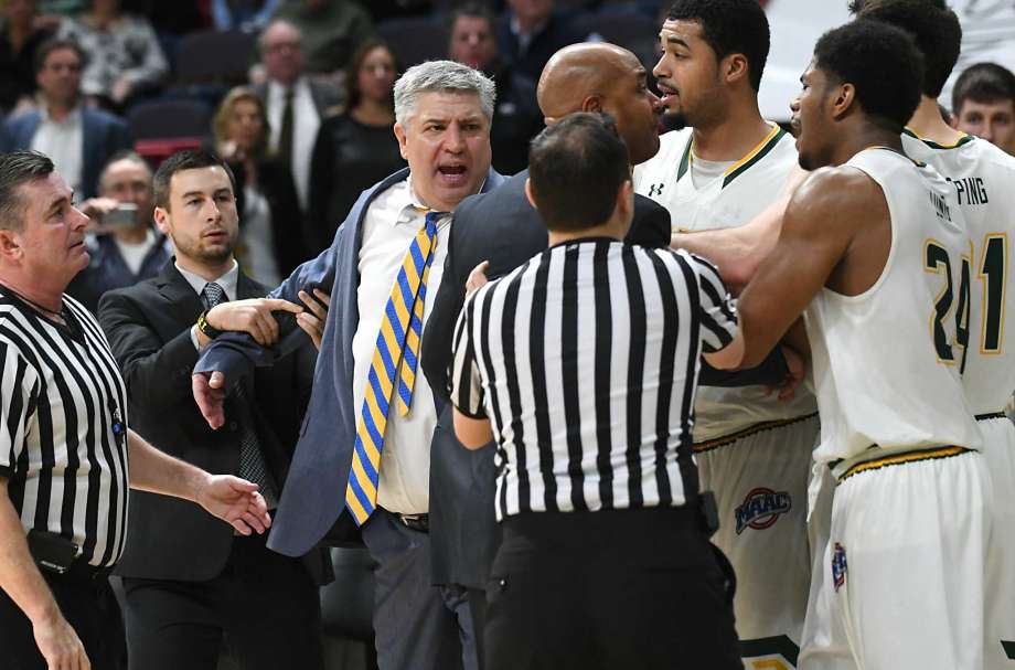 Referees and coaches try to hold back head coaches Jimmy Patsos of Siena, center, and Kevin Baggett of Rider, right of center, during a fight that broke out during a basketball game at the Times Union Center on ... more