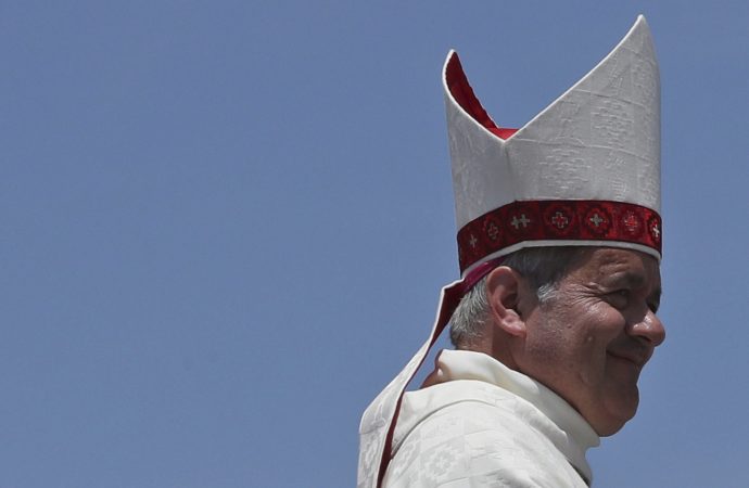 Osorno's Bishop Juan Barros smiles as he leaves the altar after Mass was celebrated by Pope Francis on Lobito Beach in Iquique, Chile, Thursday, Jan. 18, 2018. (Credit: AP Photo/Alessandra Tarantino.)