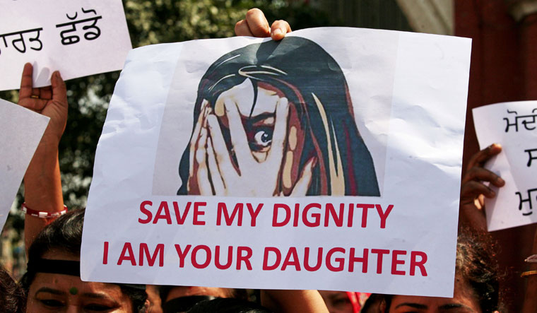 People participate in a protest against the rape of an eight-year-old Bakarwal girl near Jammu, and a teenager in Unnao, Uttar Pradesh, in Amritsar | Reuters