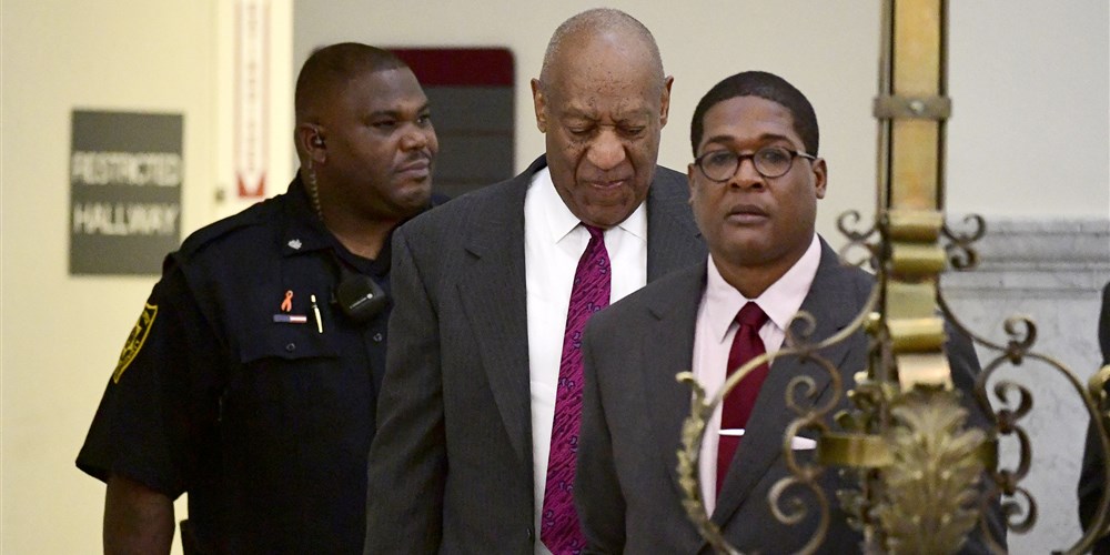 Bill Cosby arrives for his sexual assault trial led by his spokesman, Andrew Wyatt, right, at the Montgomery County Courthouse in Norristown, Pennsylvania, on Wednesday.Corey Perrine / Pool via Getty Images