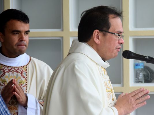 In this 2014 photo, Father Adrian Cristobal gives an opening prayer at All Souls' Day Mass at Guam Memorial Park in Barrigada. He was reassigned to the Umatac church.