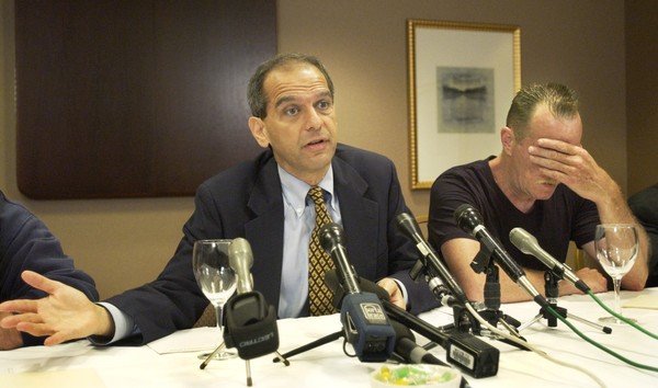 Attorney Mitchell Garabedian is pictured in this file photo from 2003 with one of the victims of clergy sex abuse in the Archdiocese of Boston. Clergy members and others in the Boston Archdiocese sexually abused more than 1,000 people over a period of six decades. (AP Photo/Elise Amendola)