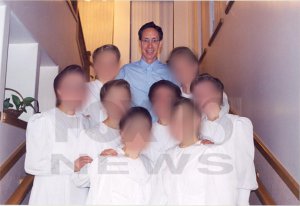 A photograph of FLDS leader Warren Jeffs and some of his wives. (Faces blurred to protect any alleged sex crimes victims.)
