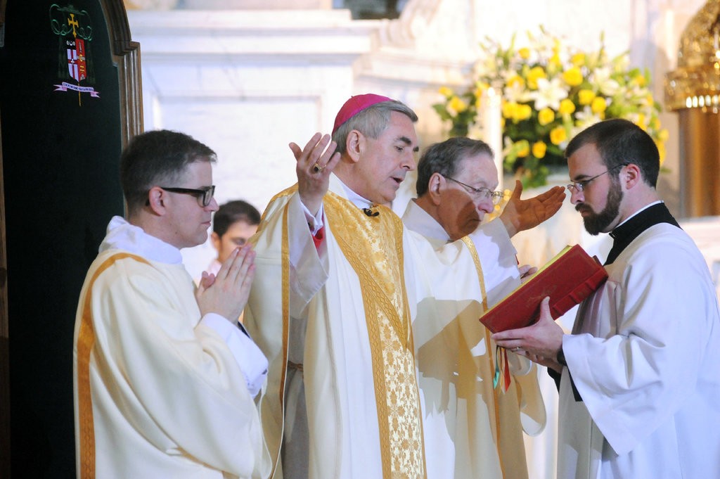 Bishop Ronald Gainer, center, has ordered that the names of former bishops dating back to the 1940s be removed from church buildings, schools and halls in the Harrisburg, Pa., diocese.