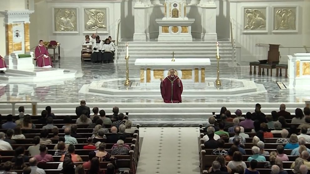 Bishop Luis Rafael Zarama kneels to address the congregation at a Mass of Reparation and Prayer for Healing in Raleigh, N.C., on Sept. 25, 2018. Image courtesy of Diocese of Raleigh