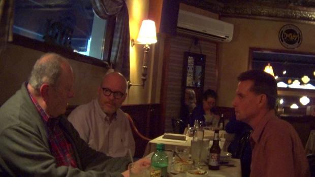 Shaun Dougherty and Brian Sabo meet with their former teacher, George Koharchik. CBS NEWS