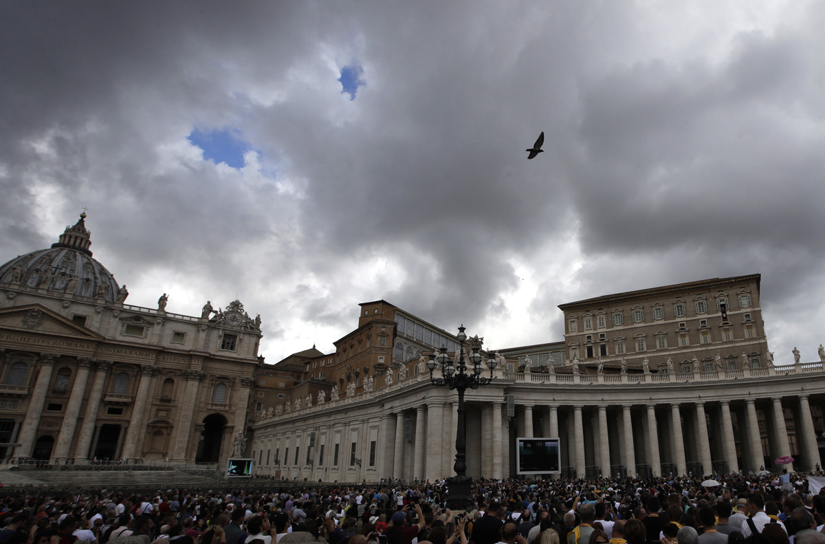 People gather in St. Peter's Square as Pope Francis recites the Angelus noon prayer from the window of his studio at the Vatican, Sunday, Oct. 7, 2018. A top Vatican cardinal issued a scathing rebuke Sunday of the ambassador who accused Pope Francis of covering up the sexual misconduct of a prominent American cardinal, saying his claims were false, "blasphemous" and demanding that he repent. (AP Photo/Alessandra Tarantino)