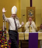 A 2008 photo of Troy Casteel, then-Director of Family Ministries for the Diocese, pointing out Bishop John Leibrecht's love of golf during a skit after Mass. (Photo: Dean Curtis/News-Leader)