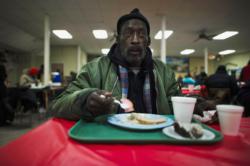 A man eats his lunch at a soup kitchen in the basement of St. Leo Catholic Church in Detroit. Leaders at U.S. Catholic organizations are cautiously monitoring the level of donations to ministries as the end-of-the-year giving season approaches, hoping that the clergy sexual abuse scandal won't negatively affect their bottom line. (CNS photo/Mark Blinch, Reuters) See ABUSE-DONATIONS-EFFECT Nov. 7, 2018.