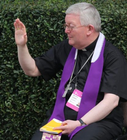 Archbishop Bernard Longley of Birmingham, England, blesses a World Youth Day pilgrim after hearing her confession in 2016 in Krakow, Poland. Archbishop Longley publicly apologized Nov. 16 to the victims of child abuse during a government-backed inquiry which shed light on allegations against priests over half a century. (CNS photo/Bob Roller)