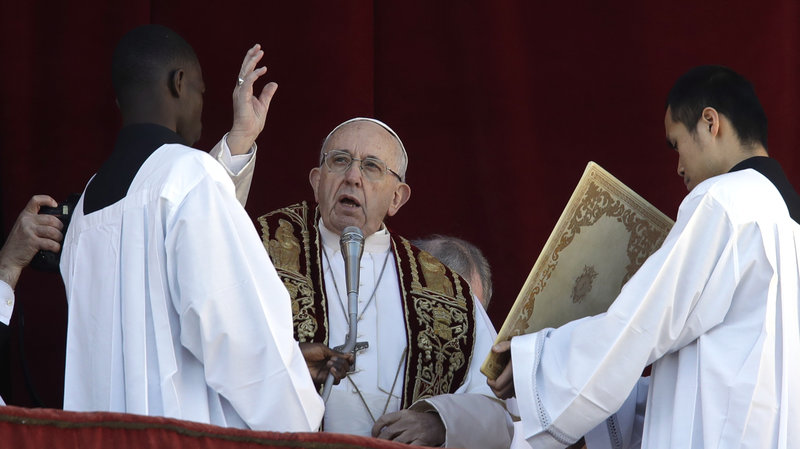 Pope Francis delivers his Christmas Day blessing from the main balcony of St. Peter's Basilica at the Vatican on Tuesday.