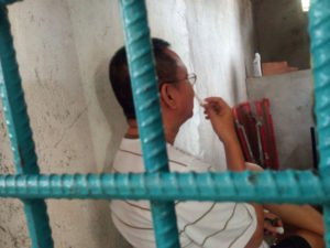 Rev. Fr. Decoroso Olmilla behind bars.