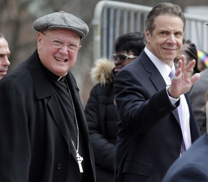 Cardinal Timothy Dolan, left, and New York Gov. Andrew Cuomo arrive for a rally to raise the minimum wage on Tuesday, March 15, 2016, in Albany, N.Y. (Mike Groll / AP)