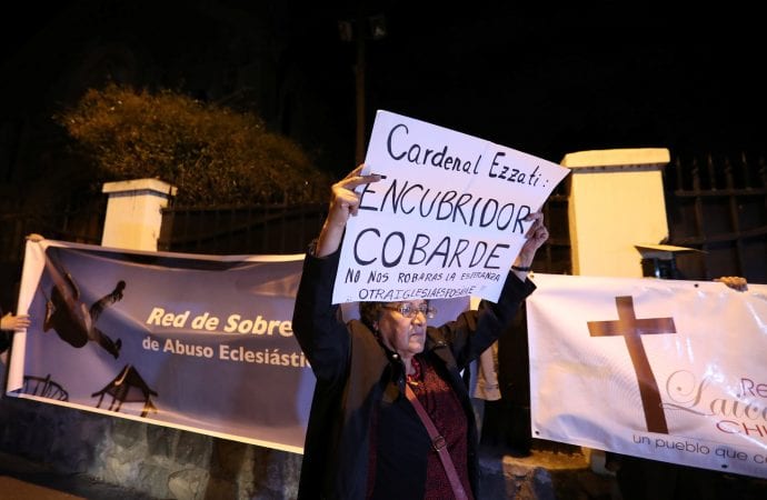 A demonstrator displays a banner during a rally against Chilean Cardinal Ricardo Ezzati over allegations he covered up sexual abuse of minors outside his residence in Santiago. The banner reads: "Cardinal Ezzati: Coward covering up! They will not steal our hope. Another church is possible" and "Survivors Network of Ecclesiastical Abuse." (Credit: CNS photo/Ivan Alvarado, Reuters.)