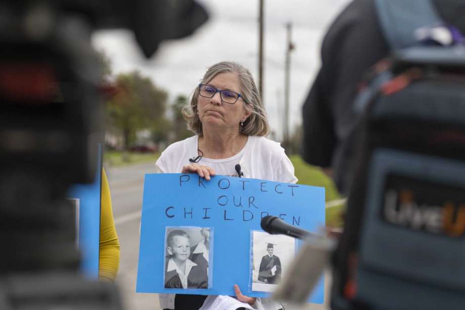 Patti Koo holds a sign with another victim of sexual assault who did not want to be identified by name during press conference, March 8, outside the San Antonio archdiocese headquarters discussing the finding of four more priests who have served in San Antonio and have been credibly accused abuser priests. The names of the accused priests should be publicized nationwide — no matter where their transgressions took place.