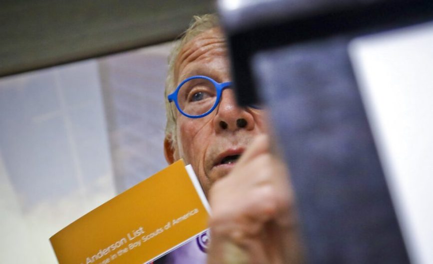 Attorney Jeff Anderson holds a list of names, during a press conference, of more than 130 Boy Scout leaders who worked in New York and were named in Boy Scouts of America (BSA) “Perversion Files” as having allegations of sexually abusing minors, Tuesday April 23, 2019, in New York. (AP Photo/Bebeto Matthews)