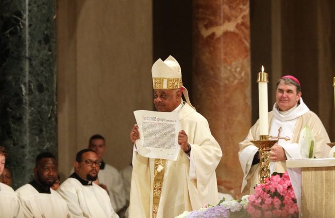 Archbishop Wilton D. Gregory displays the papal bull on his appointment to Washington during his installation Mass at the Basilica of the National Shrine of the Immaculate Conception in Washington May 21, 2019. (Credit: CNS)