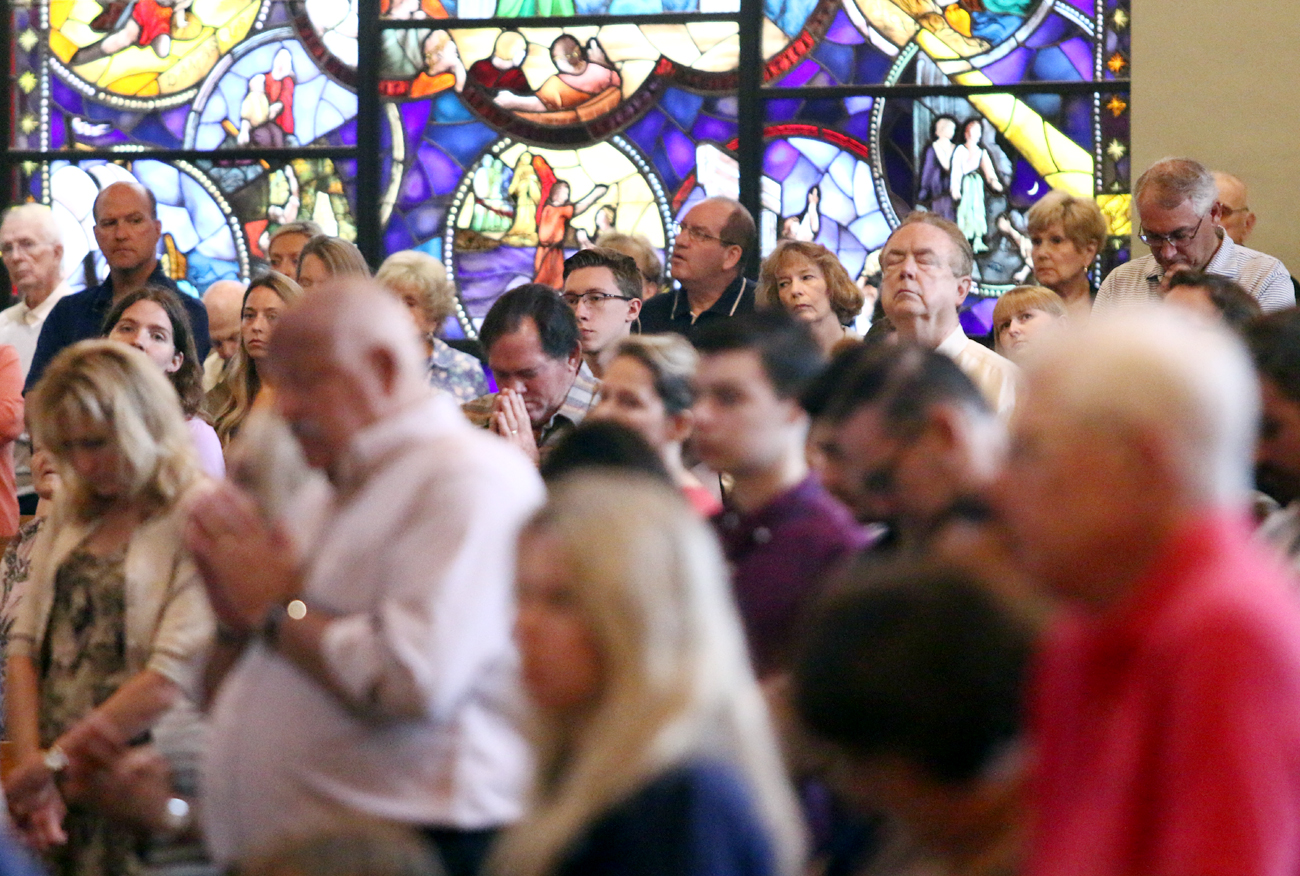 The faithful pray during a Sunday Mass at St. Andrew Church, Newtown, in July 2018. (Photo by Sarah Webb)