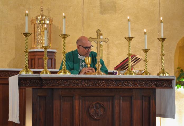 Father Tonos celebrating daily Mass at St. John the Evangelist Catholic Church in Oxford. Photo by Meagan Harkins.
