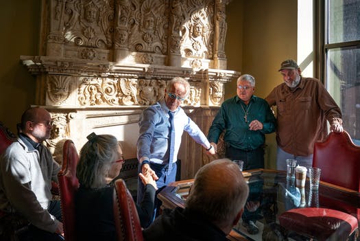 Attorney Jeff Anderson held hands with Ron Vasek and his wife Patty as he met privately with abuse survivors Ron Vasek and Pat Matuseski, right, before holding a news conference where he called for the removal of Bishop Richard Malone of Buffalo, N.Y., and Bishop Michael Hoeppner of Crookston who he accuses of sheltering abusive priests.