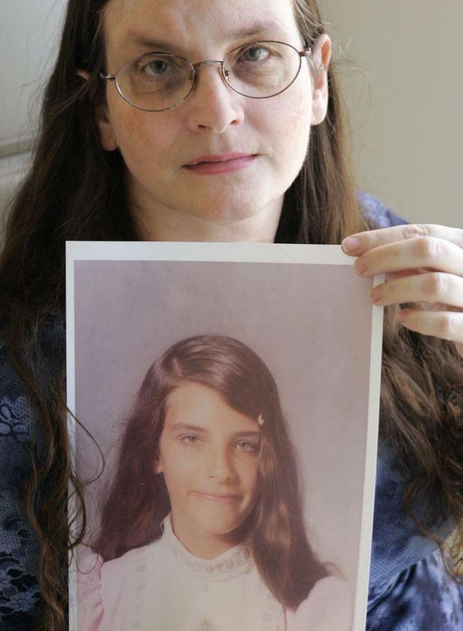 Debbie Vasquez holds a photographer of herself at age 14. Vasquez says she was raped by a Southern Baptist pastor as a teenager. (AP Photo/Donna McWilliam)Photo: Donna McWilliam, STF / AP