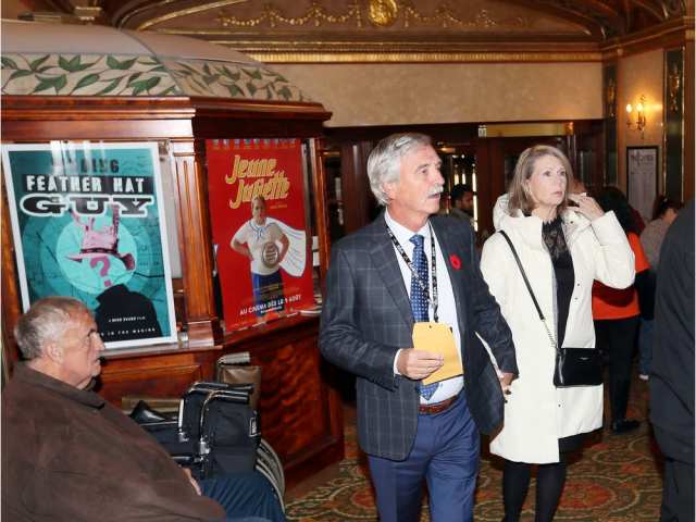 Abuse victim Rod MacLeod, centre, holds the hand of Carol Ash, right, as they enter the lobby of Capitol Theatre for opening night of the film PREY during Windsor International Film Festival. NICK BRANCACCIO / WINDSOR STAR