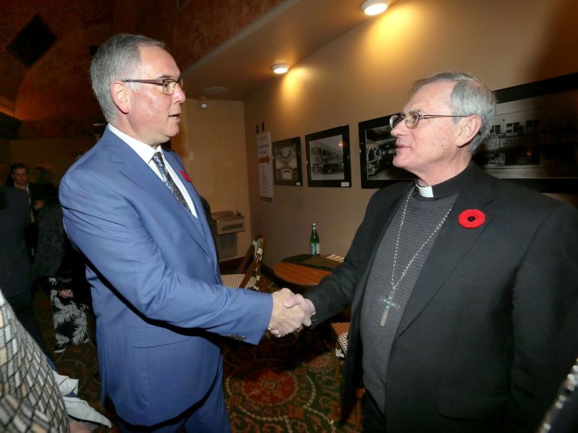 Catholic church abuse survivor Pat McMahon, left, greets Bishop Ronald Fabbro during the opening night of the film PREY at Capitol Theatre Wednesday. NICK BRANCACCIO / WINDSOR STAR