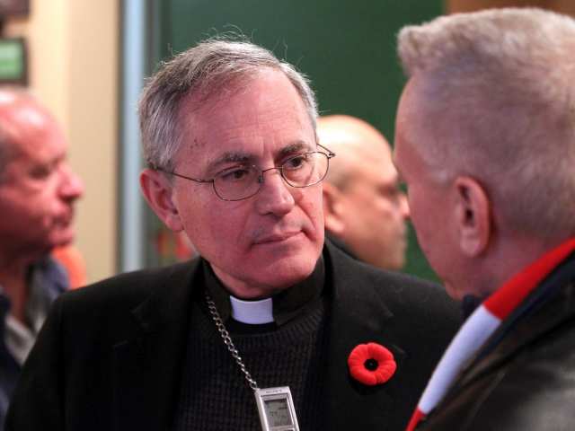 Bishop Ronald Fabbro speaks with reporter Dave Waddell while he attends opening night of the film PREY during WIFF at Capitol Theatre Wednesday. NICK BRANCACCIO / WINDSOR STAR