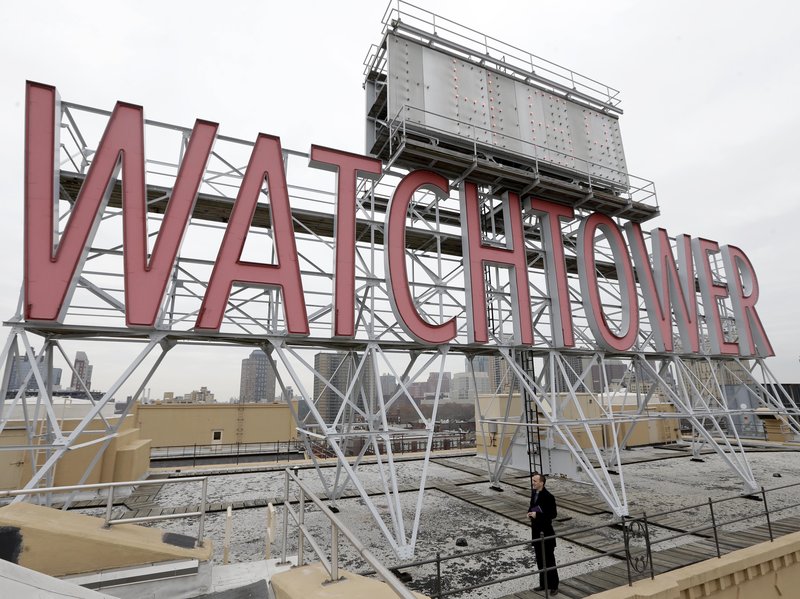 Two women who were sexually abused as children say the Jehovah's Witnesses failed to report their abuser to authorities in Montana and instead expelled him from the congregation as punishment until he repented. Pictured, in 2015, is a sign atop the then-world headquarters of the Jehovah's Witnesses in New York.