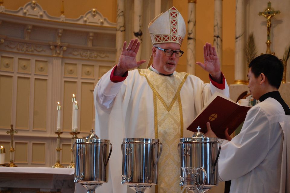 Bishop Christopher Coyne of Burlington, Vermont, blesses holy oil during the chrism Mass at St. Joseph Cathedral April 16, 2019. (CNS/Vermont Catholic magazine/Cori Fugere Urban)