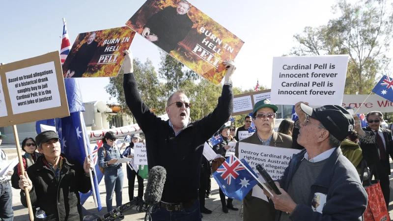 Rival groups clash outside the George Pell hearing at the High Court in Canberra.