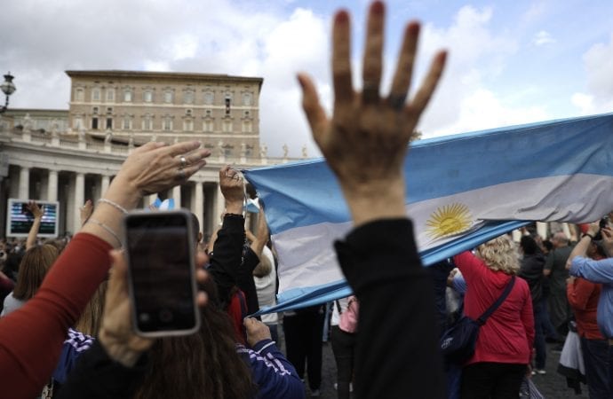 Argentina's pilgrims wave and hold flag as Pope Francis delivers his blessing during the Angelus noon prayer from his studio window overlooking St. Peter's Square at the Vatican, Sunday, Nov. 3, 2019. (Credit: Gregorio Borgia/AP.)