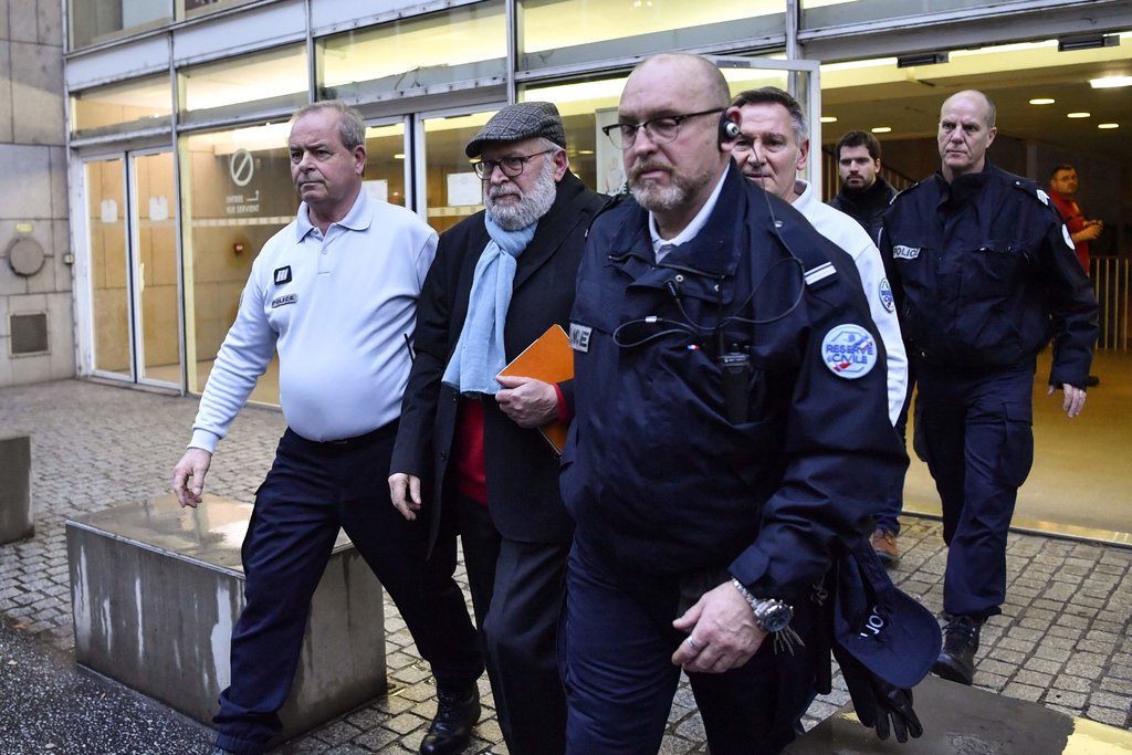 Bernard Preynat, second from left, leaving court in Lyon, France, in January. He used his former position as a Boy Scout leader to sexually abuse dozens from the 1970s to the 1990s.