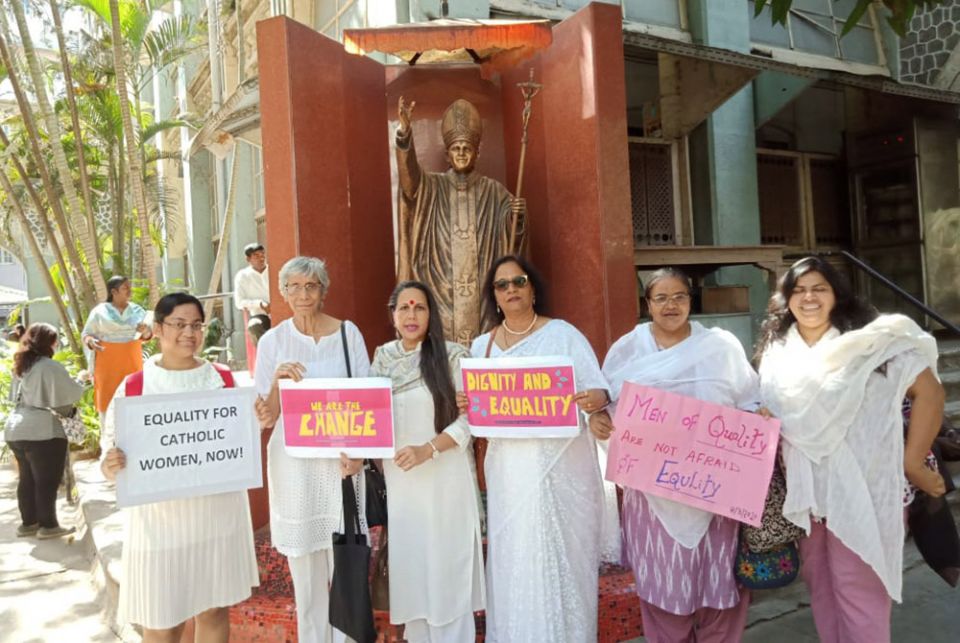 Several of the signatories of the petition to Mumbai Cardinal Oswald Gracias stand together in front of a statue of Pope John Paul II near Mumbai's Holy Name Cathedral March 8. The author of the commentary is third from the left. Virginia Saldanha is second from the left. (Photo courtesy of Astrid Lobo Gajiwala/ Catholic Women's Council)