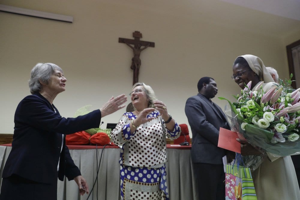 In a file photo, Karlijn Demasure, center, congratulate Sister Makamatine Lembo after she successfully defended her dissertation on the sexual abuse of religious sisters by priests, at the Pontifical Gregorian University, in Rome, Thursday, Sept. 26, 2019. (Credit: Gregorio Borgia/AP.)